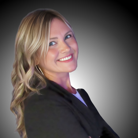 Woman with blonde hair smiling against a gray background